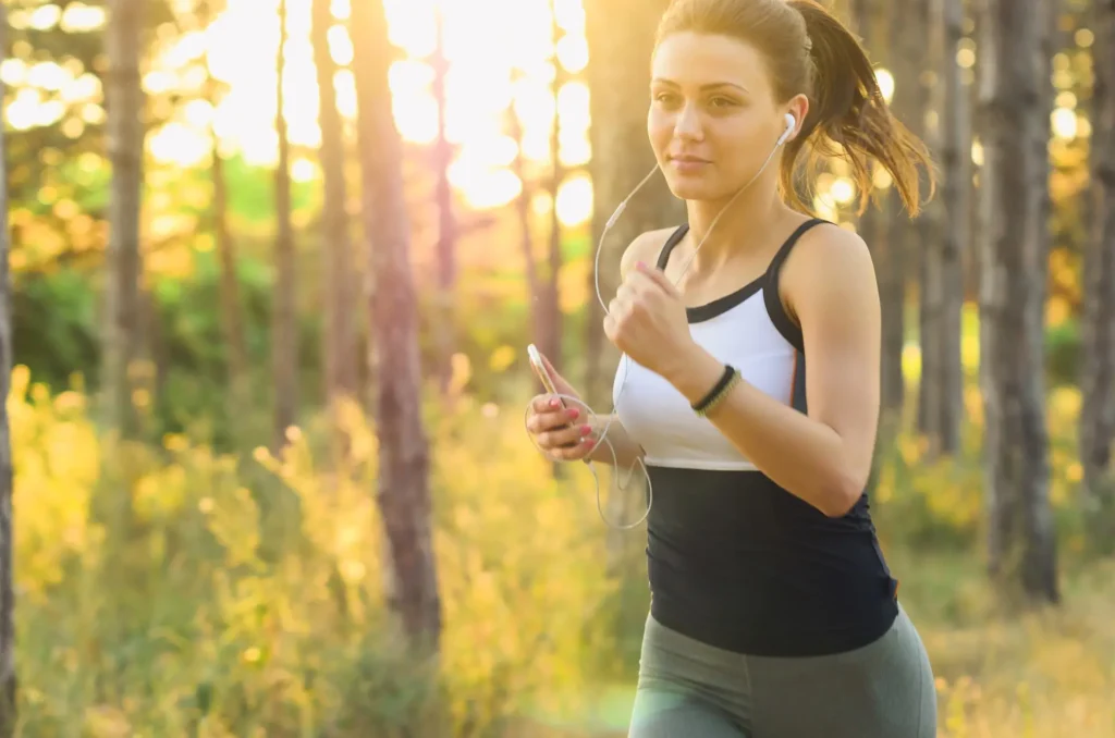 Happy people cooking healthy meals and exercising outdoors together.